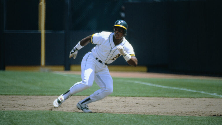 Oakland A's Ricky Henderson races toward the all-time Major League stolen base record, 118 in one season, held by Lou Brock. Notching his 109th against the California Angels, he leads off 1st base (Rod Carew 1b); (B) sprints away (pitcher Ken Forsch turns); (C) dives toward 2nd (Tim Foli waits to throw with Bobby Grich back up); (D) slides under Foli; (E) beats Foli's tag; and (F) gets the safe sign.