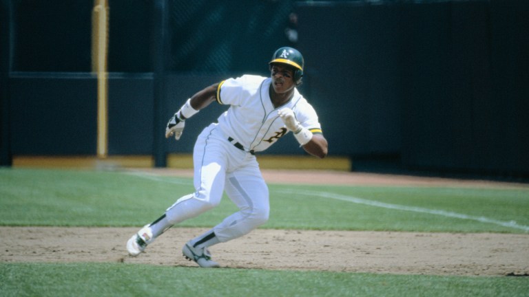 Oakland A's Ricky Henderson races toward the all-time Major League stolen base record, 118 in one season, held by Lou Brock. Notching his 109th against the California Angels, he leads off 1st base (Rod Carew 1b); (B) sprints away (pitcher Ken Forsch turns); (C) dives toward 2nd (Tim Foli waits to throw with Bobby Grich back up); (D) slides under Foli; (E) beats Foli's tag; and (F) gets the safe sign.