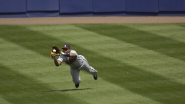 Atlanta Braves outfielder and Hall of Fame candidate Andruw Jones in action, making a diving catch.