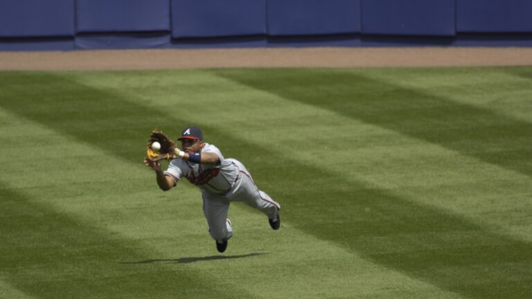 Atlanta Braves outfielder and Hall of Fame candidate Andruw Jones in action, making a diving catch.
