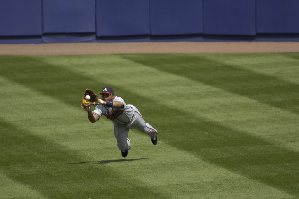 Atlanta Braves outfielder and Hall of Fame candidate Andruw Jones in action, making a diving catch.