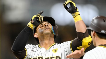 Donovan Solano of the San Diego Padres points skyward after hitting a single during the second inning of a baseball game against the Houston Astros at Petco Park.