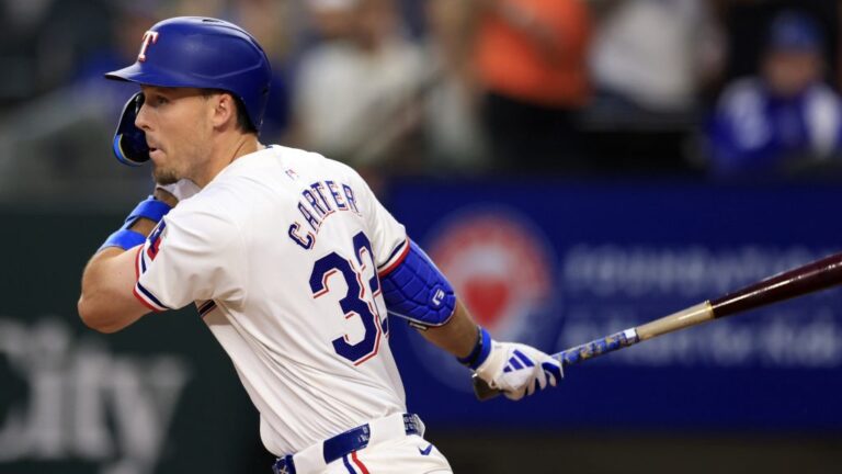 ARLINGTON, TX - APRIL 5: Evan Carter #32 of the Texas Rangers doubles against the Houston Astros at Globe Life Field on April 5, 2024 in Arlington, Texas. (Photo by Ron Jenkins/Getty Images)
