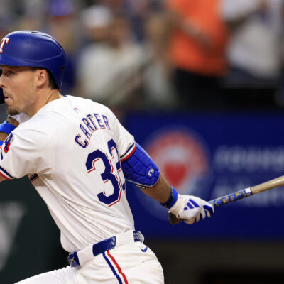 Evan Carter of the Texas Rangers doubles against the Houston Astros.
