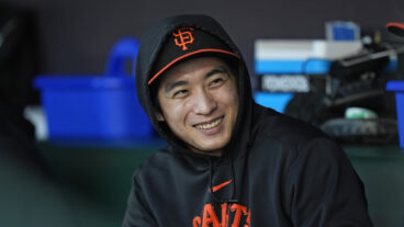 Jung Hoo Lee of the San Francisco Giants watches the game from the dugout at Oracle Park.