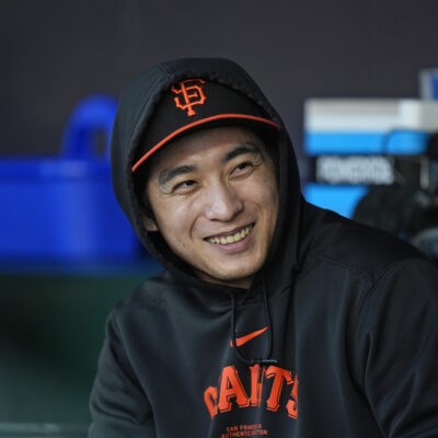Jung Hoo Lee of the San Francisco Giants watches the game from the dugout at Oracle Park.