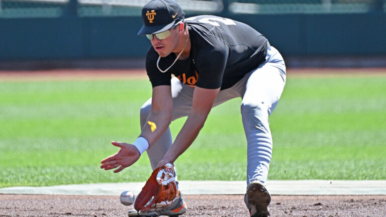 MLB Draft candidate Dean Curley of the Tennessee Volunteers fields a ground ball during pre-game warm-ups before playing the Texas A&M Aggies at the NCAA Division I Baseball Championship.