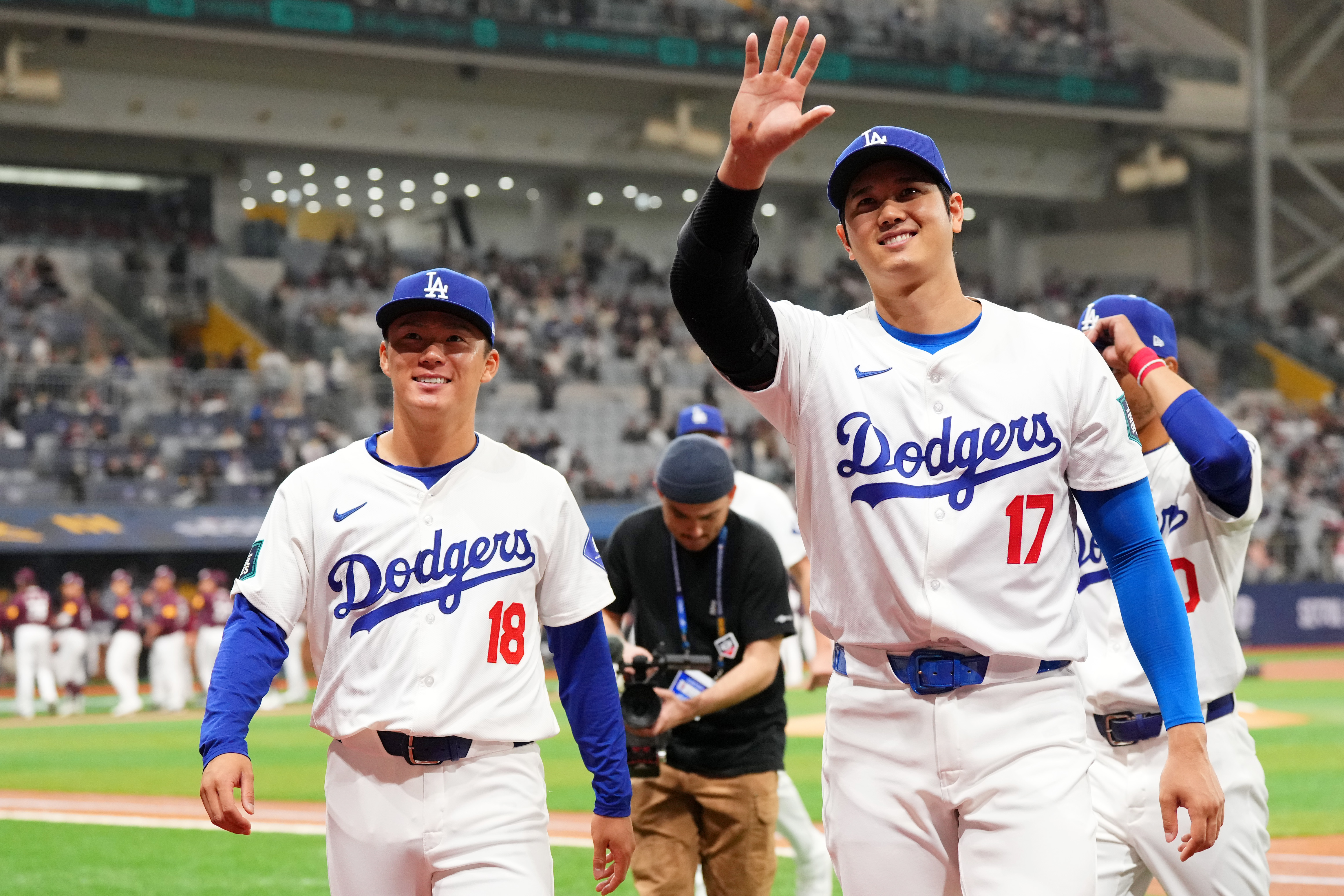 Yoshinobu Yamamoto and Shohei Ohtani of the Los Angeles Dodgers applaud fans prior to the exhibition game between Los Angeles Dodgers and Kiwoom Heroes at Gocheok Sky Dome.