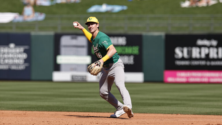 Cooper Bowman of the Oakland Athletics fields during a spring training game against the Kansas City Royals at Surprise Stadium.