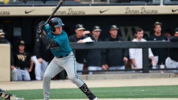 Caden Bodine of the Coastal Carolina Chanticleers goes for a swing against the Wake Forest Demon Deacons at David F. Couch Ballpark.