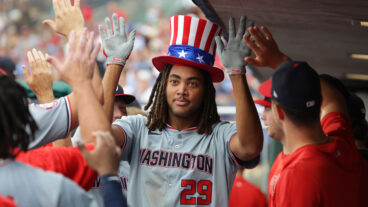 PHILADELPHIA, PENNSYLVANIA - AUGUST 18: James Wood #29 of the Washington Nationals is congratulated by teammates in the dugout after hitting a solo home run in the ninth inning during a game against the Philadelphia Phillies at Citizens Bank Park on August 18, 2024 in Philadelphia, Pennsylvania. The Nationals won 6-4. (Photo by Hunter Martin/Getty Images)
