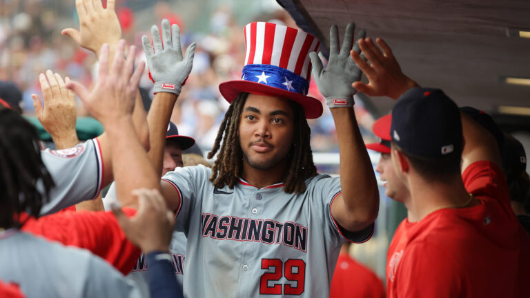 PHILADELPHIA, PENNSYLVANIA - AUGUST 18: James Wood #29 of the Washington Nationals is congratulated by teammates in the dugout after hitting a solo home run in the ninth inning during a game against the Philadelphia Phillies at Citizens Bank Park on August 18, 2024 in Philadelphia, Pennsylvania. The Nationals won 6-4. (Photo by Hunter Martin/Getty Images)