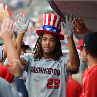 PHILADELPHIA, PENNSYLVANIA - AUGUST 18: James Wood #29 of the Washington Nationals is congratulated by teammates in the dugout after hitting a solo home run in the ninth inning during a game against the Philadelphia Phillies at Citizens Bank Park on August 18, 2024 in Philadelphia, Pennsylvania. The Nationals won 6-4. (Photo by Hunter Martin/Getty Images)