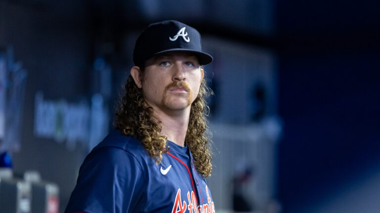 Grant Holmes of the Atlanta Braves looks on from the dugout during the game between the Atlanta Braves and the Miami Marlins at loanDepot park.