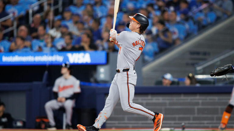 Jackson Holliday of the Baltimore Orioles hits a two-run home run to score in Eloy Jiménez #72 in the seventh inning of their MLB game against the Toronto Blue Jays at Rogers Centre.