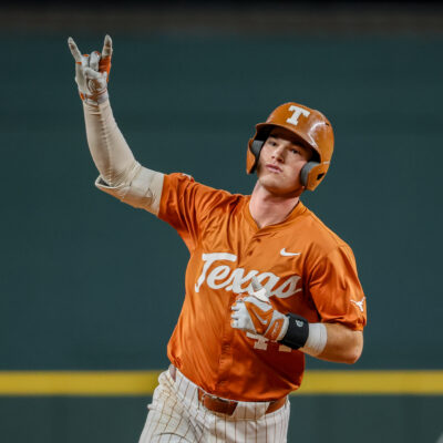 Texas outfielder Max Belyeu holds up the Hook 'Em Horns sign after hitting a home run during the 2024 Phillips 66 Big 12 Baseball Championship game between Texas and Cincinnati.