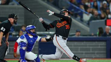 TORONTO, ONTARIO - MARCH 27: Adley Rutschman #35 of the Baltimore Orioles reacts after hitting a home run against the Toronto Blue Jays during the first inning on Opening Day at Rogers Centre on March 27, 2025 in Toronto, Ontario. (Photo by Vaughn Ridley/Getty Images)
