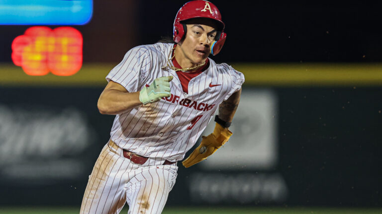 Arkansas infielder Wehiwa Aloy runs to third base in the NCAA regional game between the Arkansas Razorbacks and the Kansas State Wildcats.