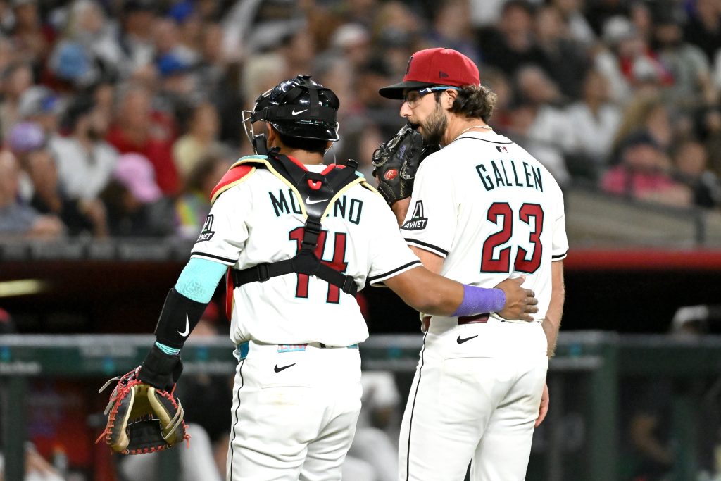 PHOENIX, ARIZONA - MARCH 27: Gabriel Moreno #14 talks with Zac Gallen #23 of the Arizona Diamondbacks in the third inning against the Chicago Cubs on Opening Day at Chase Field on March 27, 2025 in Phoenix, Arizona. (Photo by Norm Hall/Getty Images)