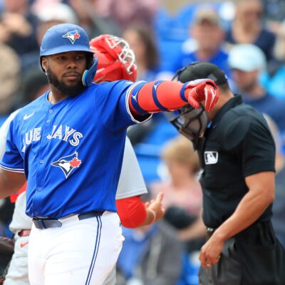 DUNEDIN, FL - FEBRUARY 25: Toronto Blue Jays DH Vladimir Guerrero Jr. (27) points at a friend in the St. Louis dugout during the spring training game between the St. Louis Cardinals and the Toronto Blue Jays on February 25, at the TD Ballpark in Dunedin, FL. (Photo by Cliff Welch/Icon Sportswire via Getty Images)