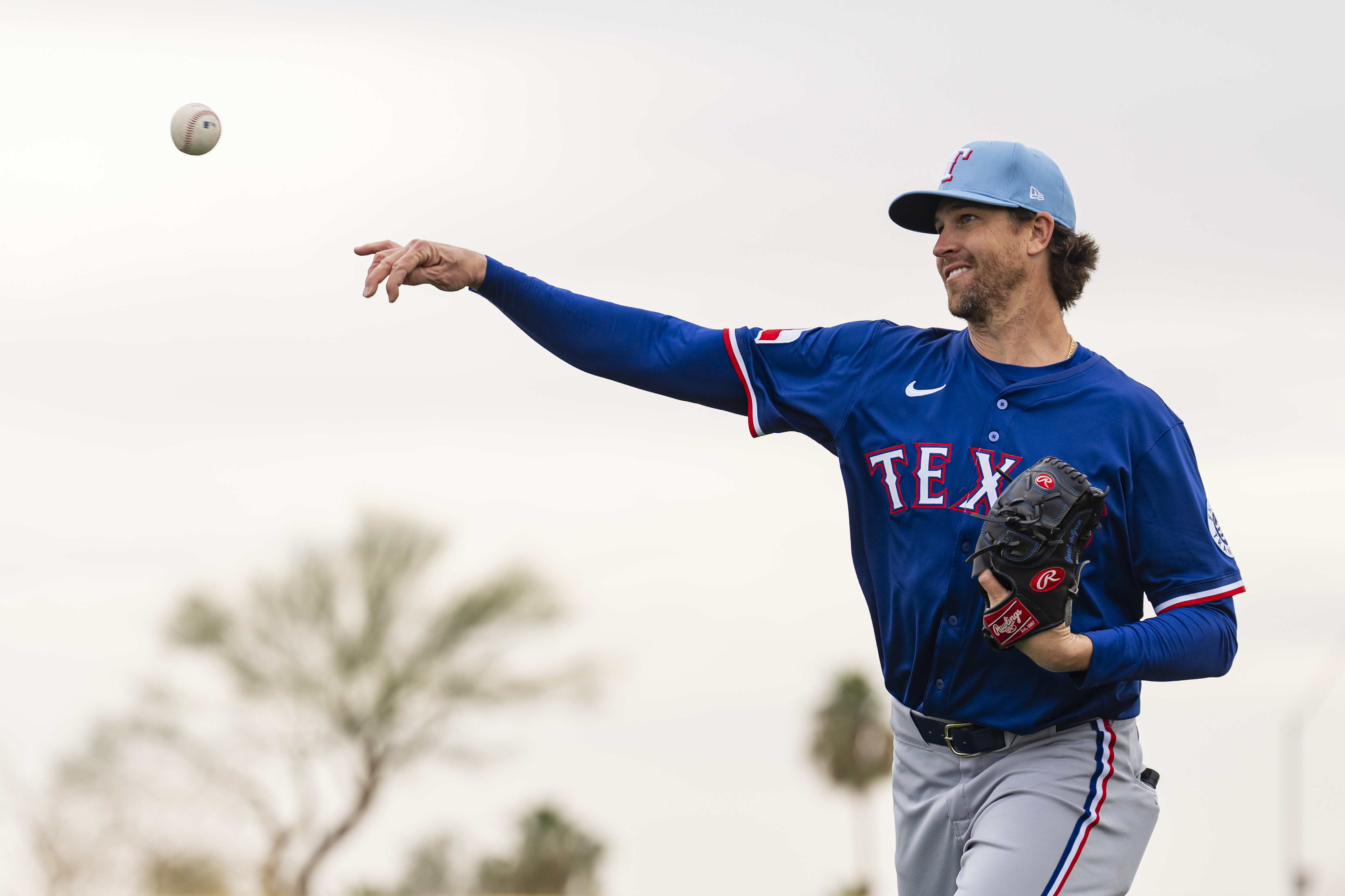 Jacob deGrom of the Texas Rangers throws during a spring training workout at Surprise Stadium.