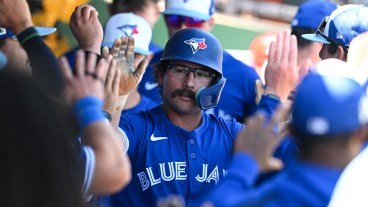 CLEARWATER, FLORIDA - MARCH 17: Davis Schneider #36 of the Toronto Blue Jays celebrates with teammates in the dugout after hitting a solo home run during the third inning of a spring training game against the Philadelphia Phillies at BayCare Ballpark on March 17, 2025 in Clearwater, Florida. (Photo by Nick Cammett/Getty Images)