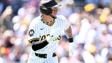 Jackson Merrill of the San Diego Padres hits a single in the first inning against the Atlanta Braves on Opening Day at Petco Park.