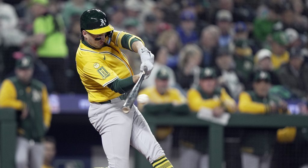 Jacob Wilson of the Athletics hits a single in the third inning against the Seattle Mariners on Opening Day at T-Mobile Park.