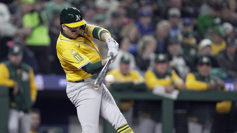 Jacob Wilson of the Athletics hits a single in the third inning against the Seattle Mariners on Opening Day at T-Mobile Park.