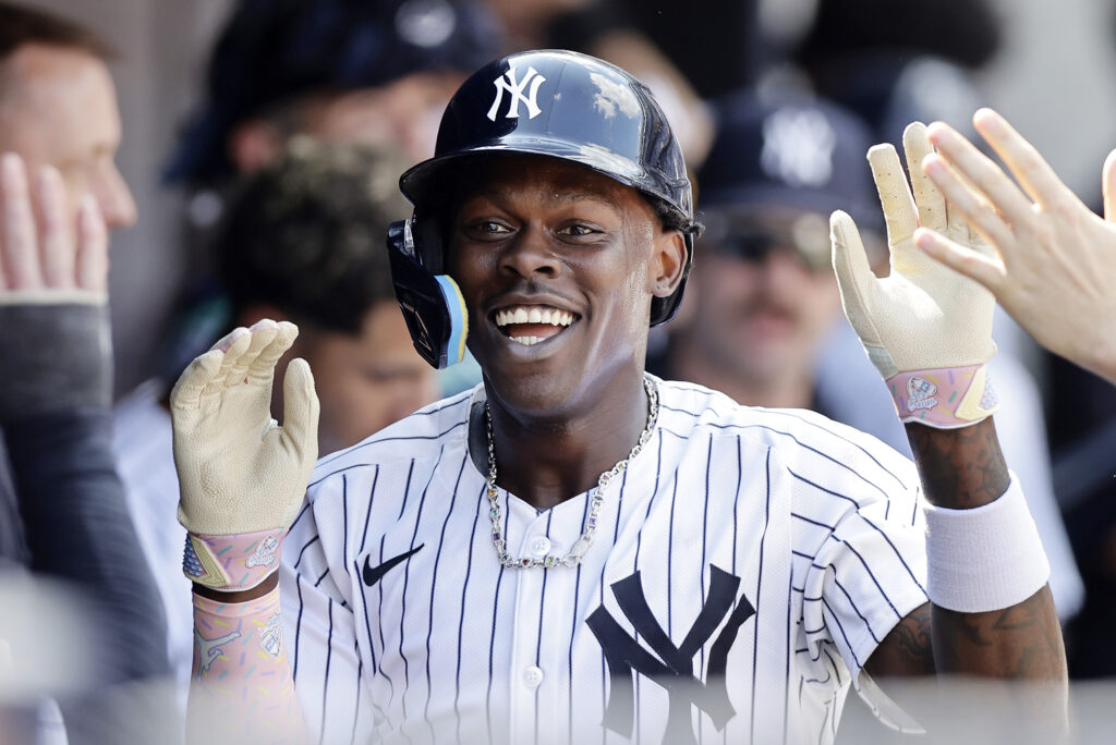 NEW YORK, NEW YORK - AUGUST 10: Jazz Chisholm Jr. #13 of the New York Yankees celebrates his eighth inning home run against the Texas Rangers in the dugout with his teammates at Yankee Stadium on August 10, 2024 in New York City. (Photo by Jim McIsaac/Getty Images)