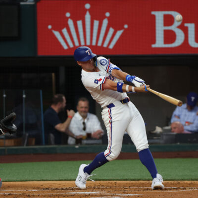 ARLINGTON, TEXAS - MARCH 27: Josh Jung #6 of the Texas Rangers hits a single during the second inning against the Boston Red Sox on Opening Day at Globe Life Field on March 27, 2025 in Arlington, Texas. (Photo by Richard Rodriguez/Getty Images)