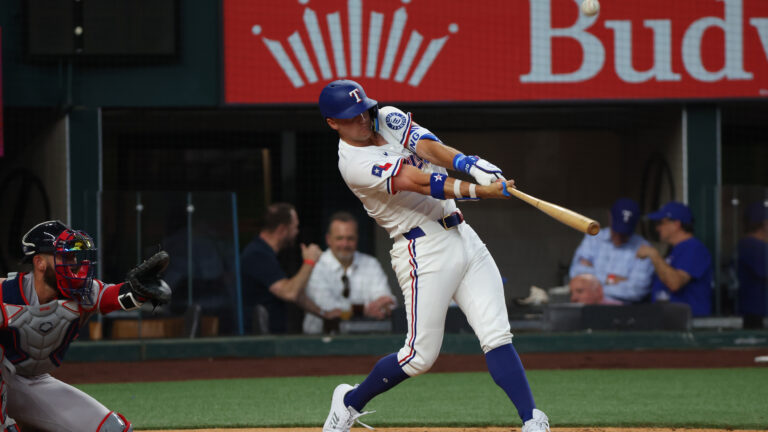 ARLINGTON, TEXAS - MARCH 27: Josh Jung #6 of the Texas Rangers hits a single during the second inning against the Boston Red Sox on Opening Day at Globe Life Field on March 27, 2025 in Arlington, Texas. (Photo by Richard Rodriguez/Getty Images)
