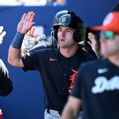 Kevin McGonigle of the Detroit Tigers celebrates with teammates after scoring on a two-run double hit by Thayron Liranzo during the seventh inning of a spring training game against the Atlanta Braves at CoolToday Park.