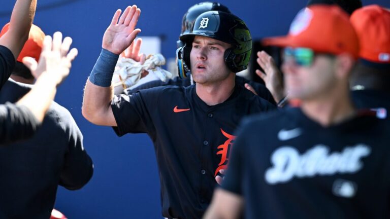 Kevin McGonigle of the Detroit Tigers celebrates with teammates after scoring on a two-run double hit by Thayron Liranzo during the seventh inning of a spring training game against the Atlanta Braves at CoolToday Park.