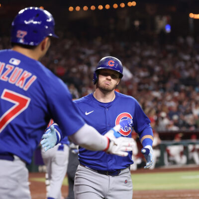 Ian Happ of the Chicago Cubs celebrates with Seiya Suzuki #27 after hitting a solo home run in the fourth inning during the game between the Chicago Cubs and the Arizona Diamondbacks at Chase Field.
