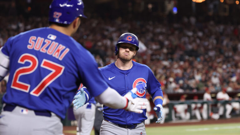 Ian Happ of the Chicago Cubs celebrates with Seiya Suzuki #27 after hitting a solo home run in the fourth inning during the game between the Chicago Cubs and the Arizona Diamondbacks at Chase Field.