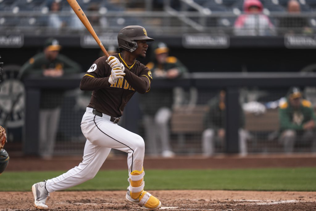 Leodalis De Vries #94 of the San Diego Padres swings and hits the ball during the Spring Breakout Game against the Athletics prospects at Peoria Sports Complex.