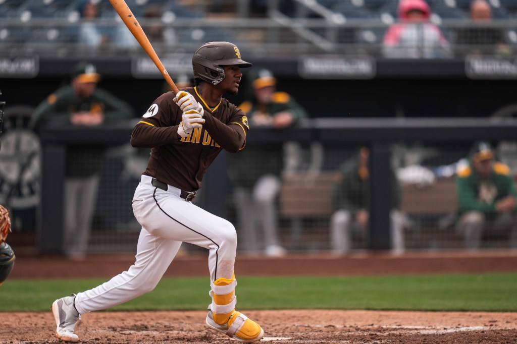Leodalis De Vries #94 of the San Diego Padres swings and hits the ball during the Spring Breakout Game against the Athletics prospects at Peoria Sports Complex.