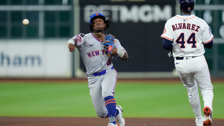 Luisangel Acuña of the New York Mets throws past Yordan Alvarez #44 of the Houston Astros for an out in the seventh inning during the game between the New York Mets and the Houston Astros at Daikin Park.