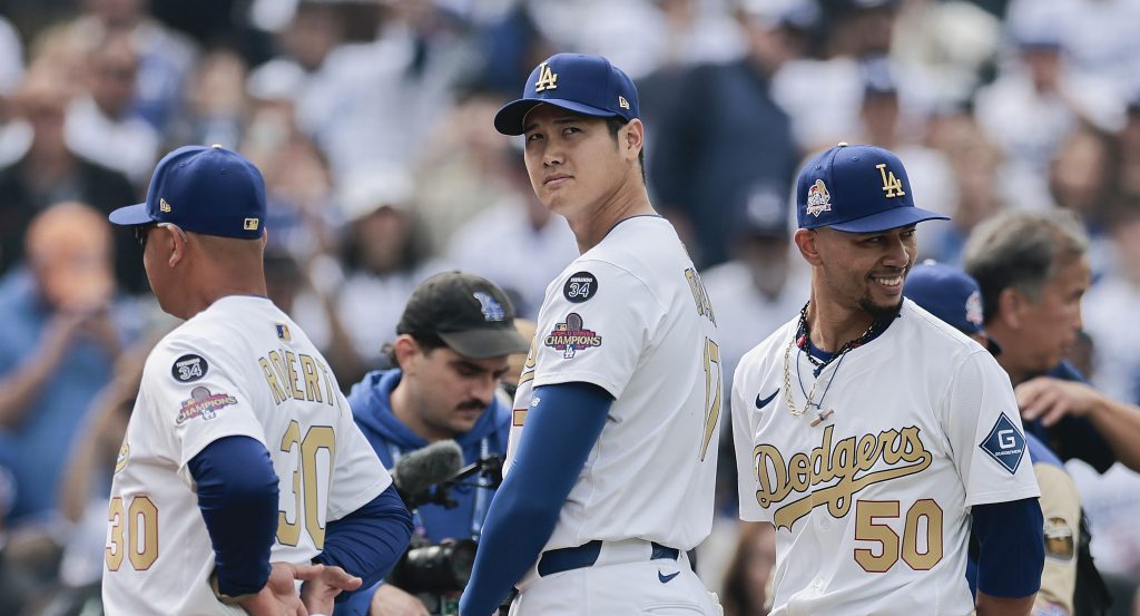 Shohei Ohtani #17 and Mookie Betts #50 of the Los Angeles Dodgers during the National Anthem before the game against the Detroit Tigers on Opening Day at Dodger Stadium.