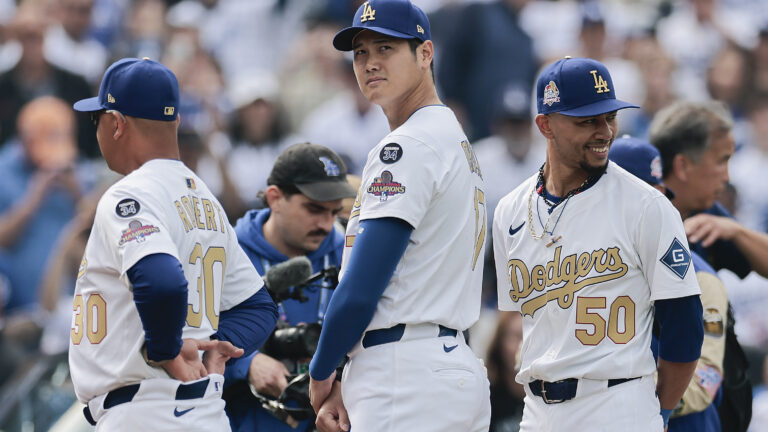 Shohei Ohtani #17 and Mookie Betts #50 of the Los Angeles Dodgers during the National Anthem before the game against the Detroit Tigers on Opening Day at Dodger Stadium.