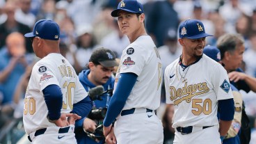 Shohei Ohtani #17 and Mookie Betts #50 of the Los Angeles Dodgers during the National Anthem before the game against the Detroit Tigers on Opening Day at Dodger Stadium.