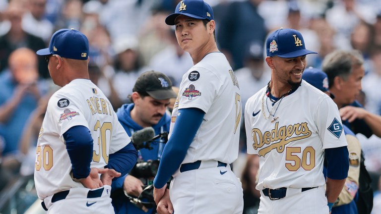 Shohei Ohtani #17 and Mookie Betts #50 of the Los Angeles Dodgers during the National Anthem before the game against the Detroit Tigers on Opening Day at Dodger Stadium.