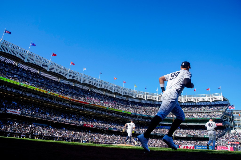Aaron Judge of the New York Yankees runs onto the field during the game against the Milwaukee Brewers on Opening Day at Yankee Stadium.