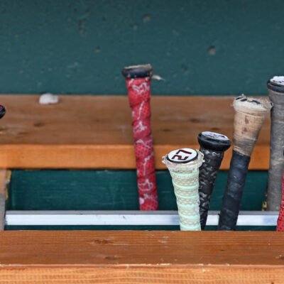 A general view Texas A&M Aggies bats in the bat rack in the dugout before the NCAA Division I Baseball Championship against the Tennessee Volunteers at Charles Schwab Field.