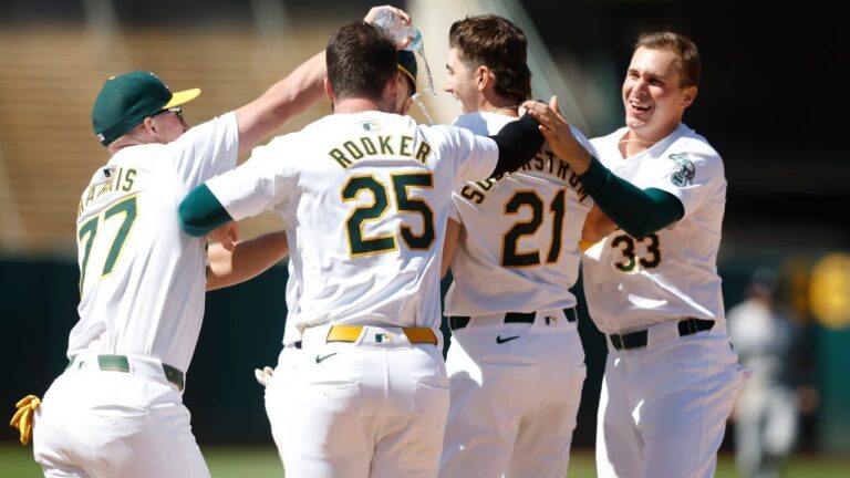 OAKLAND, CALIFORNIA - MAY 23: Tyler Soderstrom #21 of the Oakland Athletics celebrates with teammates after drawing a walk with bases loaded to win the game against the Colorado Rockies at Oakland Coliseum on May 23, 2024 in Oakland, California. (Photo by Lachlan Cunningham/Getty Images)