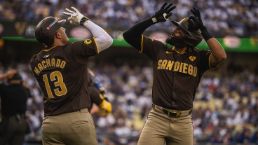 LOS ANGELES, CALIFORNIA - OCTOBER 6: Fernando Tatis Jr. #23 and Manny Machado #13 of the San Diego Padres celebrate after Tatis home run in the first inning of game two of the National League Divisional Series against the Los Angeles Dodgers at Dodger Stadium on October 6, 2024, in Los Angeles, California. (Photo by Matt Thomas/San Diego Padres/Getty Images)