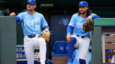 KANSAS CITY, MO - MARCH 30: Michael Massey #19 and Jonathan India #6 of the Kansas City Royals look on from the dugout prior to the game between the Cleveland Guardians and the Kansas City Royals at Kauffman Stadium on Sunday, March 30, 2025 in Kansas City, Missouri. (Photo by Daniel Shirey/MLB Photos via Getty Images)