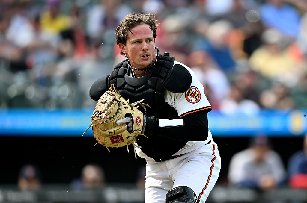 BALTIMORE, MARYLAND - APRIL 03: Adley Rutschman #35 of the Baltimore Orioles fields the ball against the Boston Red Sox at Oriole Park at Camden Yards on April 03, 2025 in Baltimore, Maryland. (Photo by G Fiume/Getty Images)