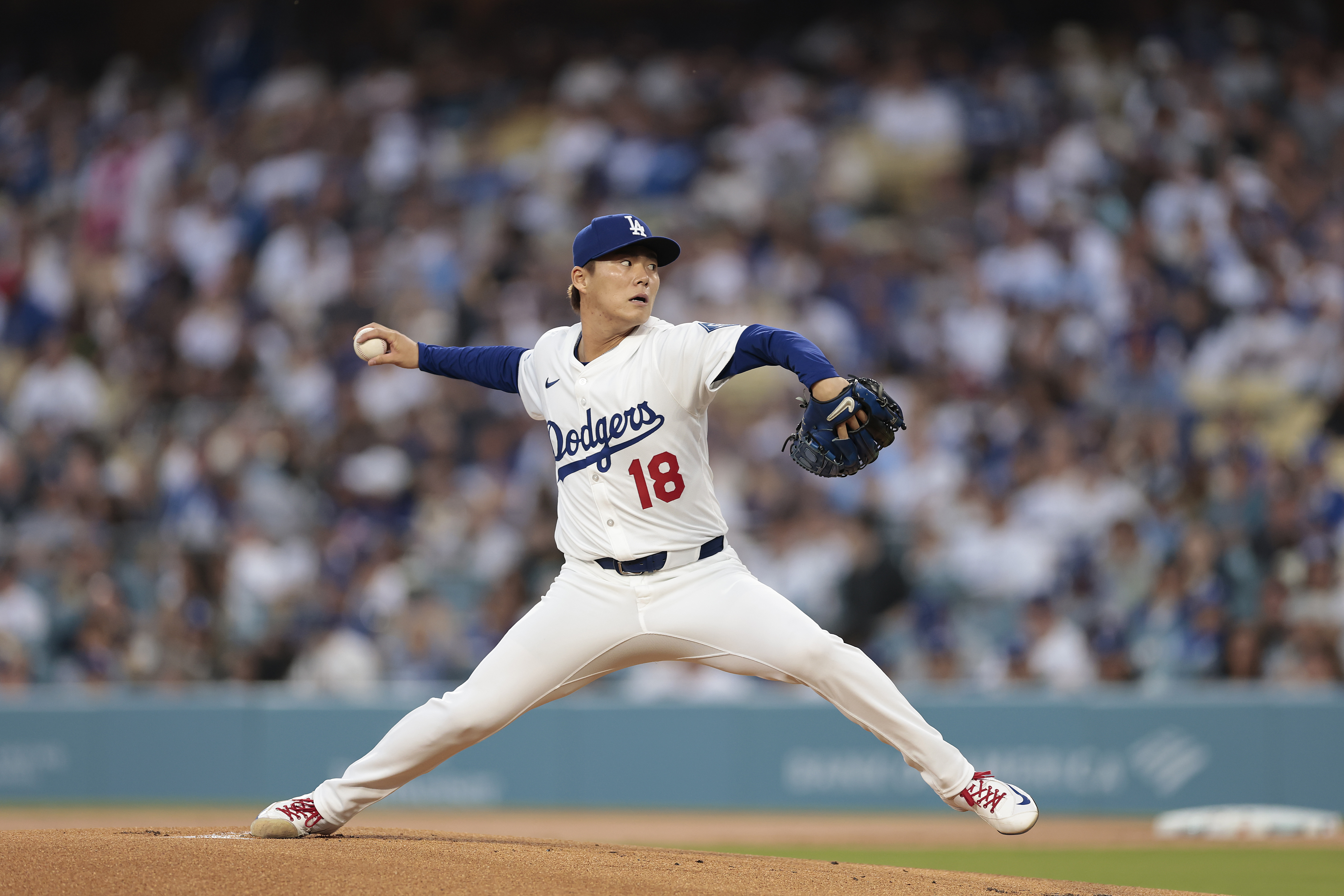 LOS ANGELES, CALIFORNIA - APRIL 11: Yoshinobu Yamamoto #18 of the Los Angeles Dodgers throws against the Chicago Cubs in the first inning at Dodger Stadium on April 11, 2025 in Los Angeles, California. (Photo by Ronald Martinez/Getty Images)